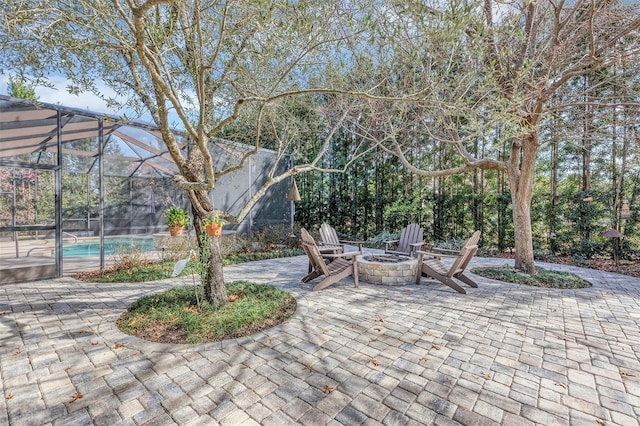 view of patio / terrace featuring a lanai and a fire pit