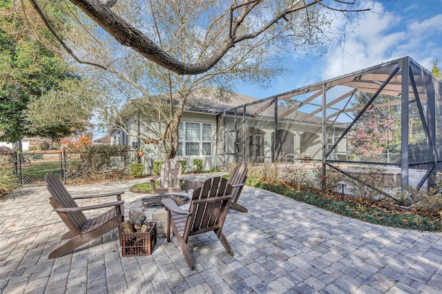 view of patio with a lanai and a fire pit