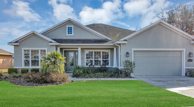 view of front of home with stucco siding, a front lawn, concrete driveway, an attached garage, and a shingled roof