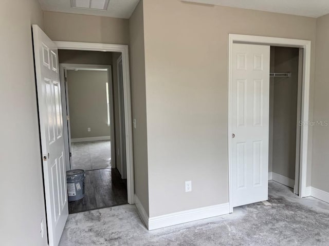 unfurnished bedroom with baseboards and a closet