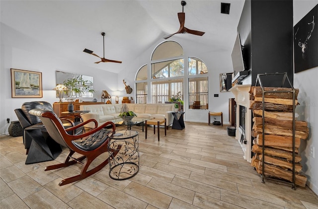 living room with high vaulted ceiling and ceiling fan