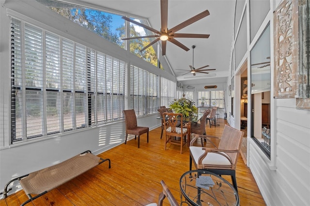 sunroom / solarium featuring lofted ceiling and ceiling fan