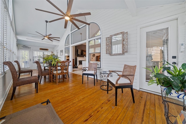 sunroom with vaulted ceiling with beams and ceiling fan