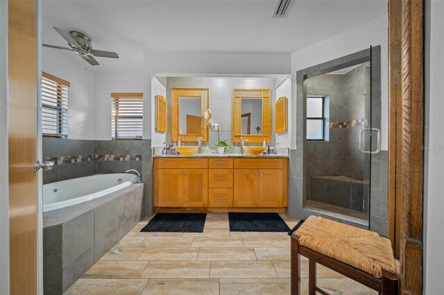 bathroom featuring vanity, ceiling fan, and separate shower and tub