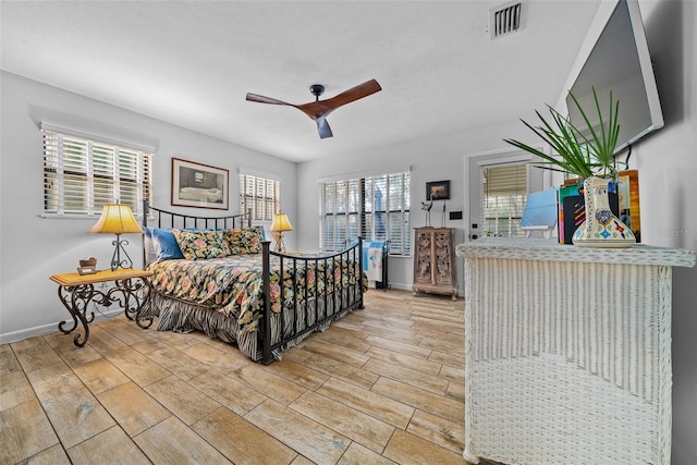 bedroom featuring ceiling fan and multiple windows