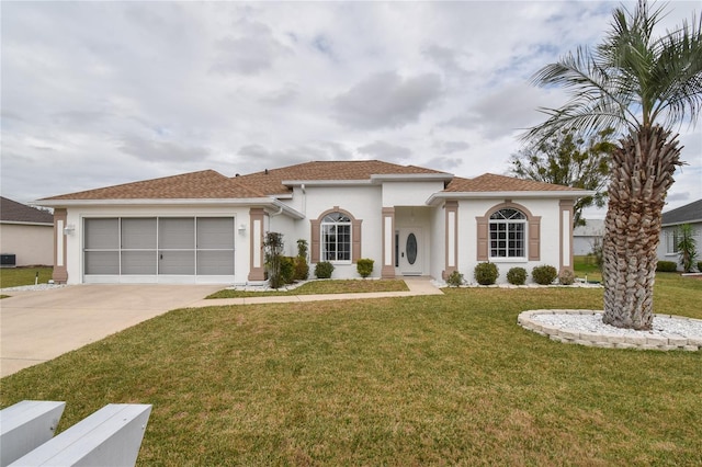 mediterranean / spanish-style house with a front yard and a garage