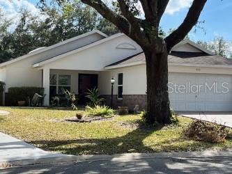 single story home with a garage and a front yard