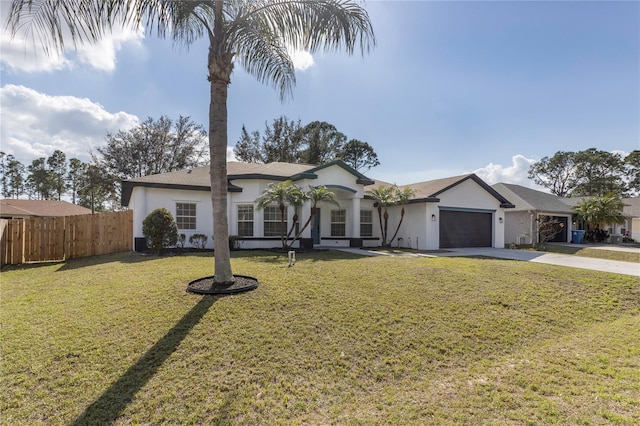 view of front of property featuring stucco siding, driveway, fence, a front yard, and a garage