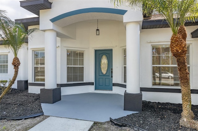 entrance to property with stucco siding