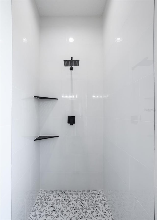 full bath featuring a tile shower