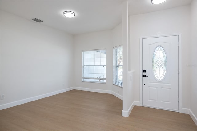 entryway featuring light wood-type flooring, visible vents, and baseboards