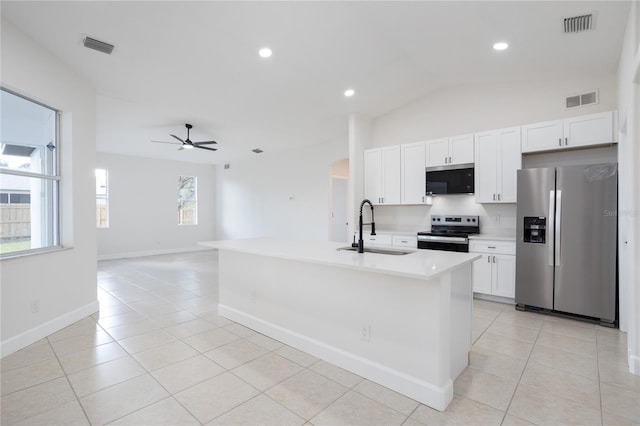 kitchen featuring a sink, stainless steel appliances, visible vents, and light tile patterned floors