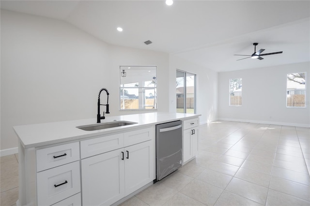 kitchen with lofted ceiling, a sink, light countertops, stainless steel dishwasher, and open floor plan