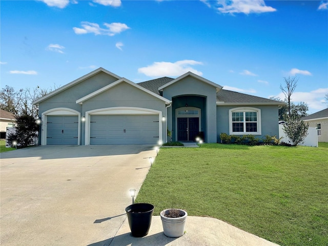 ranch-style home featuring a garage and a front yard