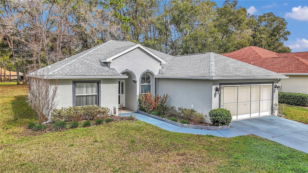 ranch-style home with a garage and a front yard