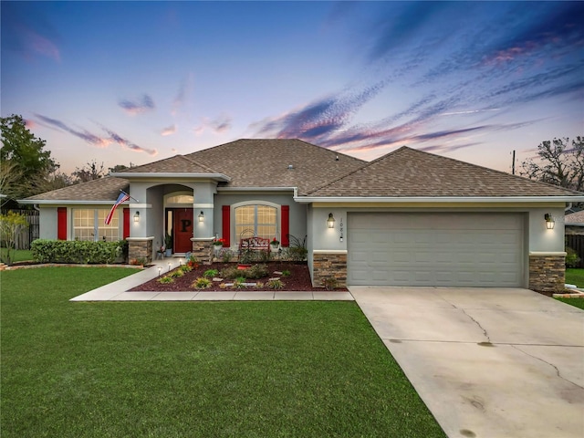 view of front of home featuring a garage and a yard