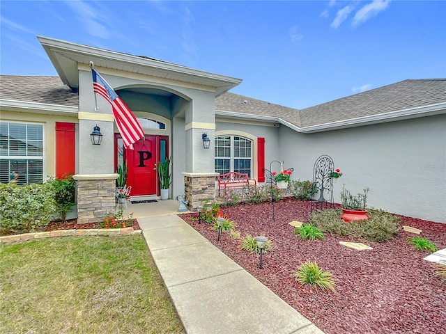 doorway to property featuring a yard