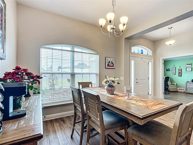 dining area featuring an inviting chandelier and dark hardwood / wood-style floors