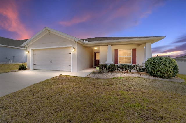 single story home with a garage and a lawn