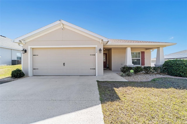 ranch-style home with a garage and central AC