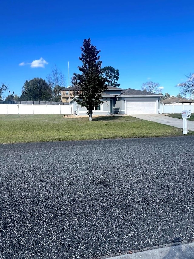 view of front of home featuring a garage and a front lawn