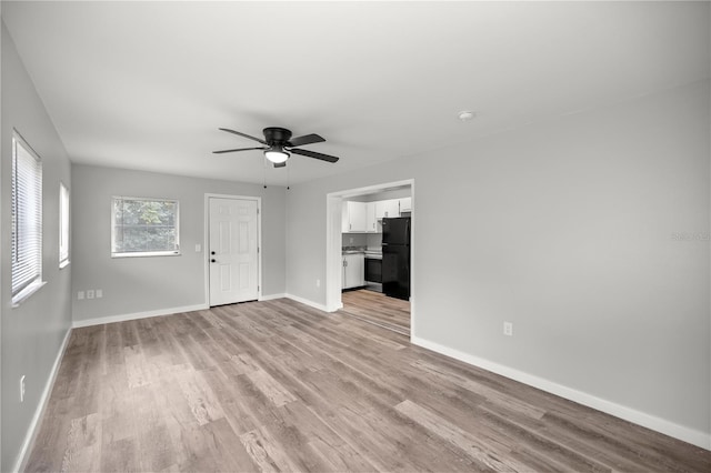 unfurnished living room with ceiling fan and light hardwood / wood-style floors