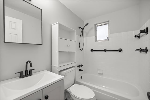 full bathroom featuring tiled shower / bath, vanity, and toilet