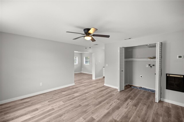 unfurnished bedroom featuring light hardwood / wood-style flooring, a closet, and ceiling fan