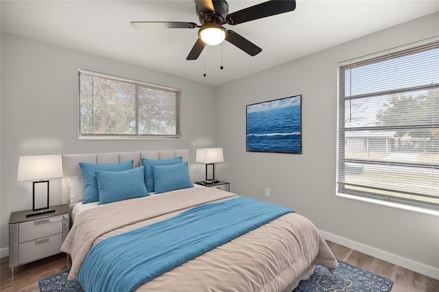 bedroom with hardwood / wood-style floors and ceiling fan