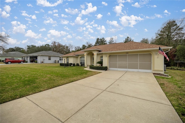 view of front of house featuring a front yard, concrete driveway, a garage, and stucco siding