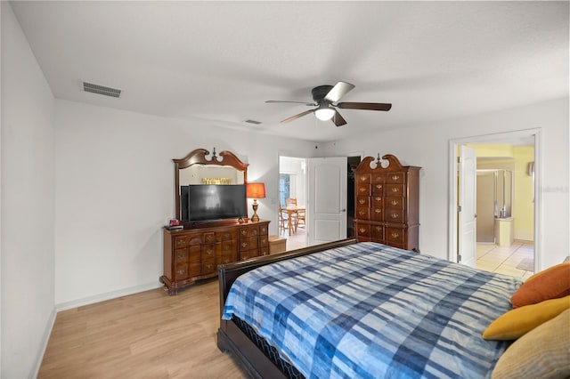 bedroom featuring ceiling fan, wood finished floors, visible vents, and baseboards