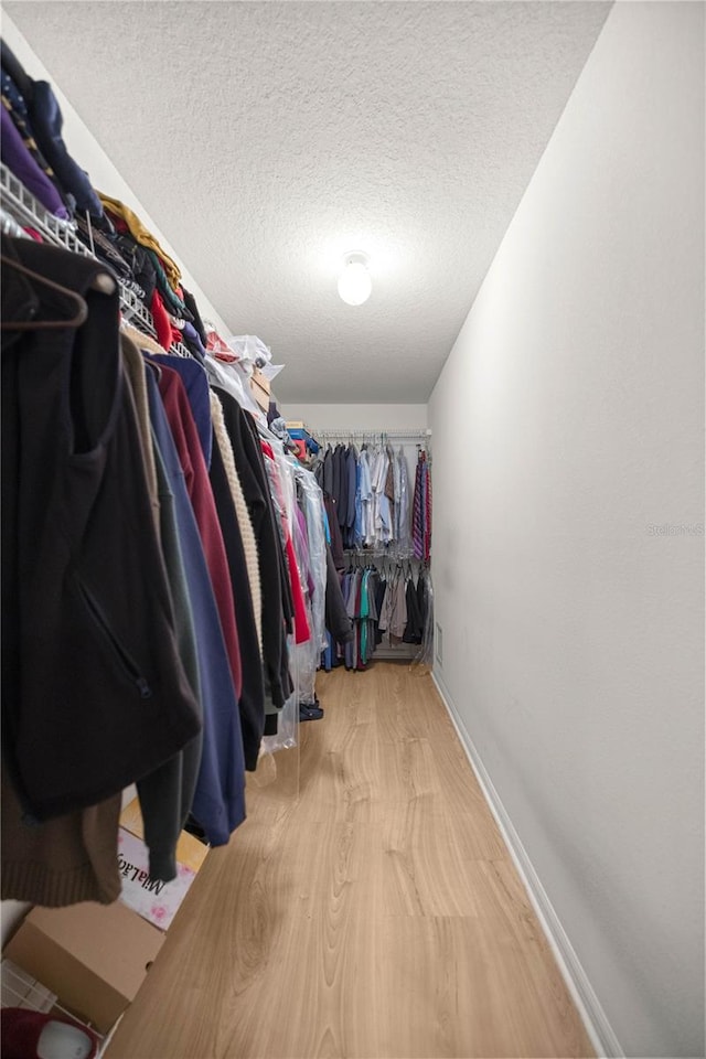 spacious closet with wood finished floors