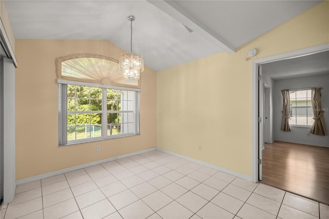 empty room with baseboards, light tile patterned floors, an inviting chandelier, and vaulted ceiling