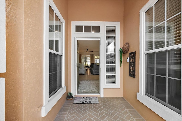 view of exterior entry with stucco siding