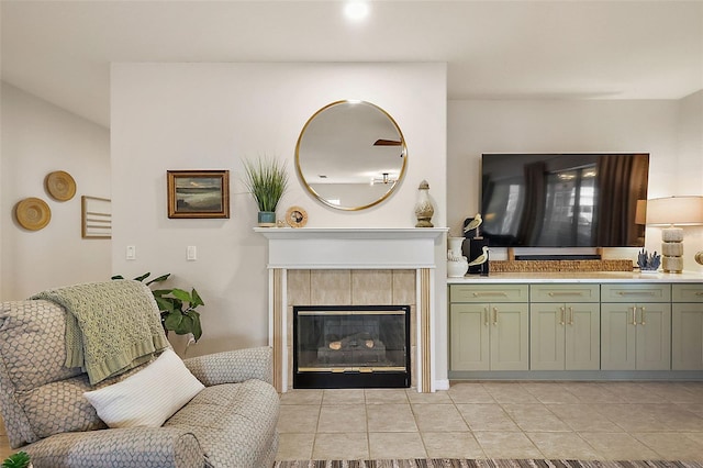 living area featuring a tiled fireplace and light tile patterned floors