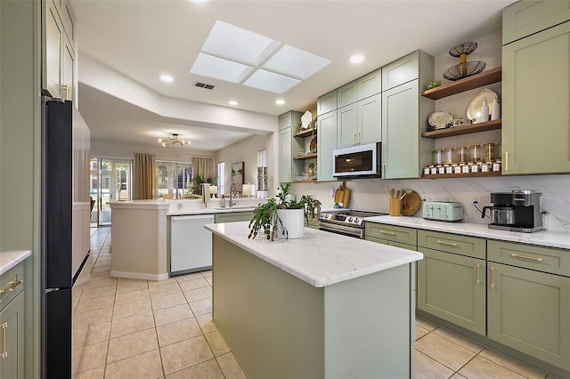 kitchen with visible vents, green cabinets, appliances with stainless steel finishes, a peninsula, and open shelves