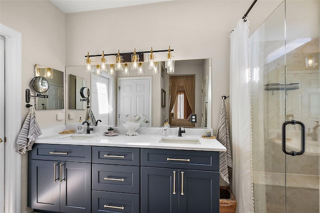 full bath featuring double vanity, a stall shower, and a sink