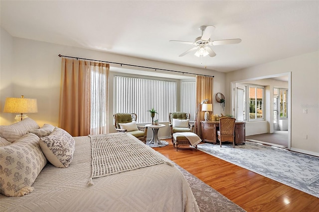 bedroom featuring baseboards, a ceiling fan, and light wood finished floors