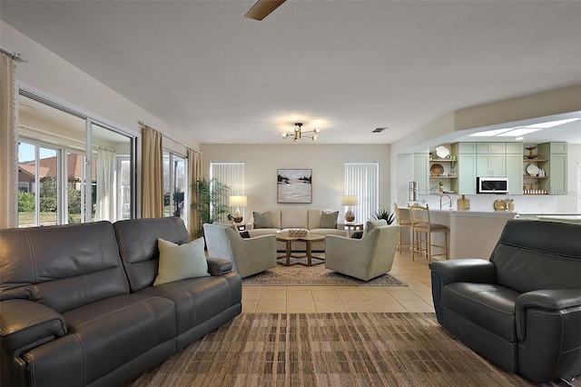 living area featuring light tile patterned flooring and visible vents