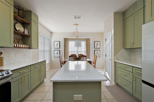 kitchen with green cabinetry, open shelves, stainless steel range with electric stovetop, and a center island