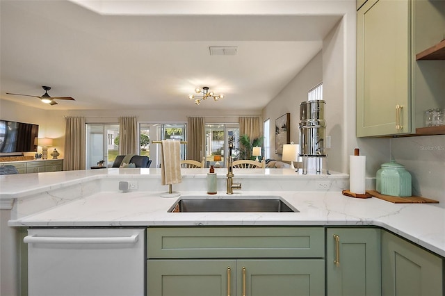 kitchen with dishwashing machine, a sink, open floor plan, and green cabinetry