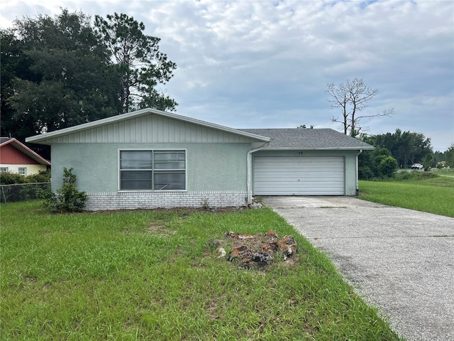 view of front facade with a garage and a front lawn