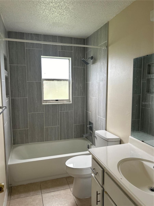 full bathroom featuring tiled shower / bath combo, vanity, toilet, tile patterned floors, and a textured ceiling