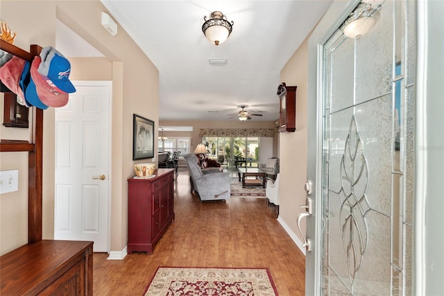 entrance foyer featuring light wood-type flooring, ceiling fan, and baseboards