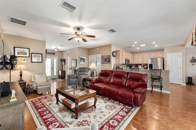 living room featuring french doors, visible vents, and light wood finished floors