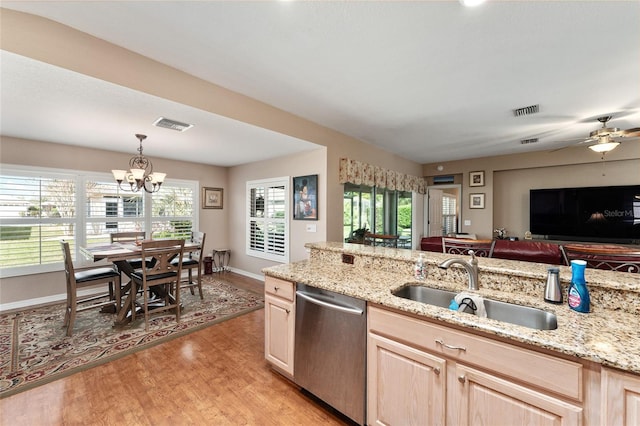 kitchen featuring visible vents, dishwasher, light wood-style flooring, light brown cabinetry, and a sink