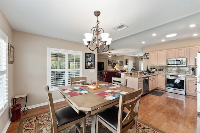 dining room with recessed lighting, visible vents, wood finished floors, baseboards, and ceiling fan with notable chandelier