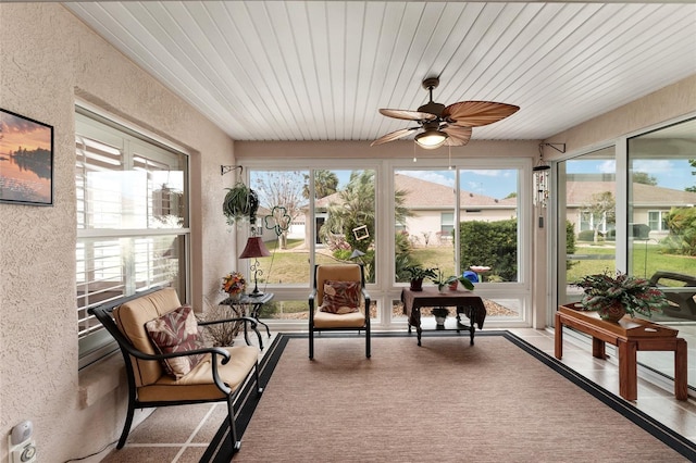 sunroom / solarium featuring ceiling fan and wood ceiling