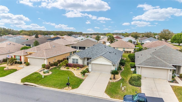 birds eye view of property with a residential view