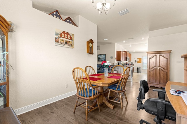 dining room with lofted ceiling and light hardwood / wood-style flooring